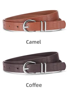 Detail of camel and brown belts with crocodile pattern and silver D-buckles