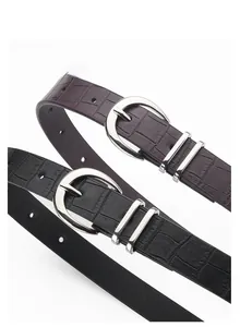 Detail of bohemian crocodile pattern leather belts with silver alloy pin buckles