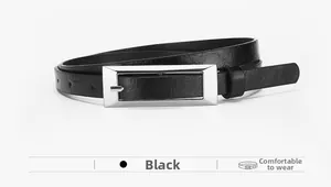 Detail of minimalist black leather belt with a rectangular silver metal buckle close-up