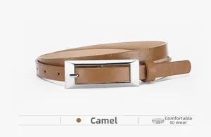 Detail view of camel leather belt with litchi texture and silver rectangle buckle