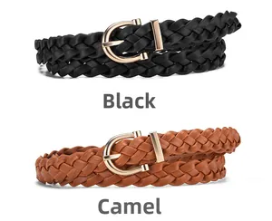 Detail of woven leather belts in black and camel colors with golden metal buckles