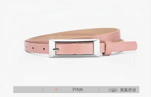 Close-up of pink faux leather thin belt with silver rectangular buckle and multi-hole design