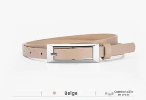 Detail view of a beige slim leather belt featuring a silver rectangular pin buckle design