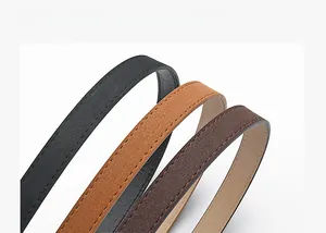 Three slim leather belts in black and brown shades with fine stitching detail