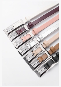 Detail of elegant slim waist belts showing diverse colors and silver rectangular buckles