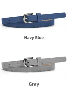 Detailed comparison of navy blue and grey suede skinny belts with silver buckles