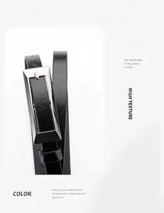 Detail of high-gloss black leather belt with a minimalist silver rectangular buckle