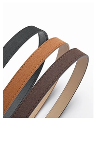 Detail of suede skinny belts in black and brown with fine stitching for dresses