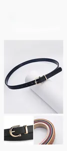 Detail of slim black leather belt with golden U-buckle and smooth oil-edge craftsmanship
