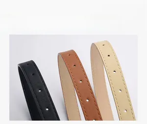 Detailed macro view showing the fine leather texture and stitching of slim fashion belts