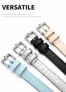 Detail of light blue faux crocodile leather belt with metallic silver buckle closure