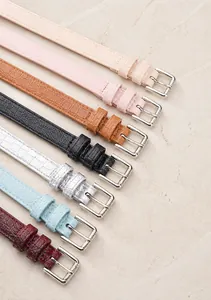 Detail of seven colored crocodile pattern belts with silver buckles for women