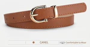 Detail of camel colored thin belt featuring lychee texture and golden horsebit buckle