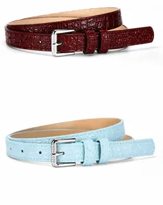 Detail view of burgundy and azure faux crocodile leather belts with silver pin buckles