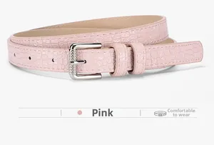 Close-up of pink women's faux crocodile belt with engraved silver buckle detail