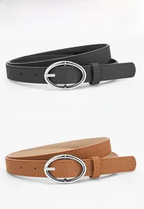 Detailed view of black and camel suede belts with silver oval metal buckles