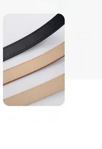 Detailed macro view of litchi texture on black and beige slim leather fashion belts
