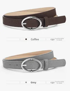 Detail of minimalist coffee and grey suede belts with polished oval metal buckles