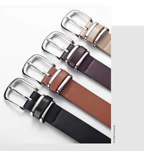 Macro detail of slim leather belts in black, brown, and beige with silver pin buckles