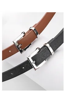 Detail of minimalist leather belts in black and brown with silver alloy pin buckles