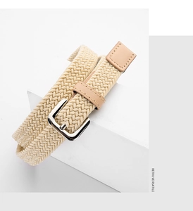 Close-up of beige elastic woven belt with silver square buckle and brown leather accents