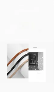 Détail de ceintures fines en similicuir tressées en marron, noir et beige classique