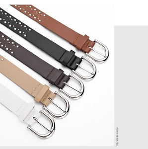 Detail of five leather belts with silver D-shaped buckles and metal stud decorations