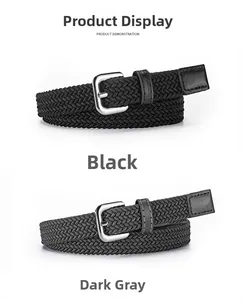 Detail of woven elastic belts in black and dark grey with silver buckle and leather trim