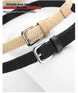 Detail view of woven stretch belts with alloy pin buckles in black and beige tones
