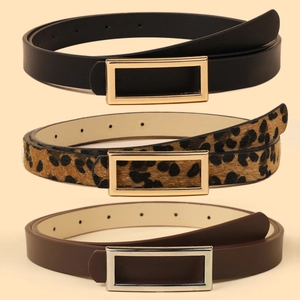 Three minimalist women's belts in black, brown, and leopard print with metal buckles