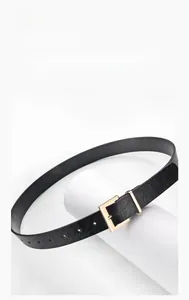 Detailed macro view of black leather belt with golden square buckle and texture