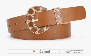 Detail of camel PU leather belt featuring vintage gold buckle with geometric patterns