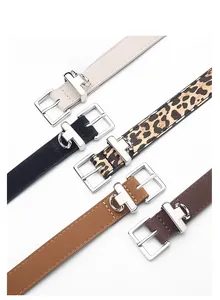 Close-up showing a collection of multi-color leather belts with silver alloy pin buckles