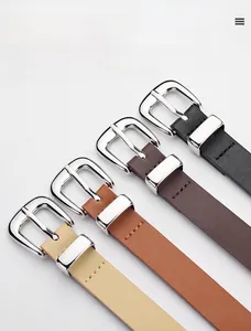 Close-up of four-color PU leather belts with silver metal buckles and cross texture