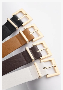 Detail of four colorful leather belts for women with polished gold square metal buckles
