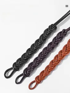 Detailed view of woven leather belts in black, purple, and caramel brown colors