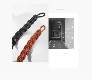 Macro detail of hand-woven leather belt straps in classic black and vintage brown leather