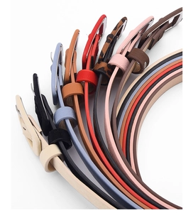 Selection of slim fashion belts for women in multiple colors with classic metal buckles