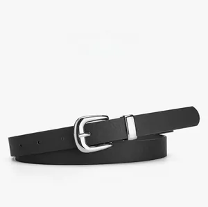 Detail of silver oval pin buckle and black textured leather belt on white background