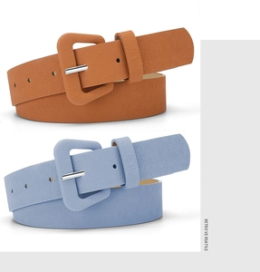 Close-up of textured leather belts in orange and blue with matching square buckles
