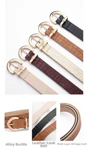 Detailed close-up of thin faux leather women belts with crocodile pattern and D-shaped buckles