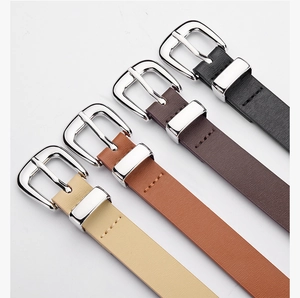 Close-up of minimalist PU leather belts in four classic colors with silver metal buckles