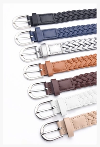 Macro detail of multi-color woven leather belts with classic silver D-ring buckles
