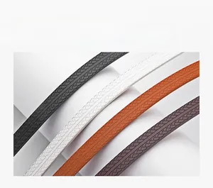 Close-up detail of premium embossed leather straps in black, white, orange and dark brown