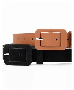 Close-up of classic black and brown textured belts featuring metal pin buckles