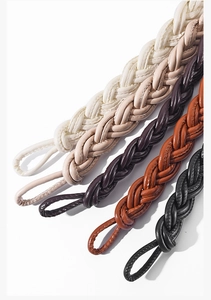 Detail of woven leather skinny belts in five colors with intricate braided texture and loops