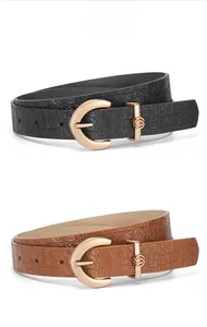 Close-up of black and camel PU leather belts with gold buckles and croc texture