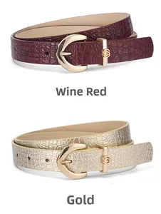 Detail of wine red and gold crocodile embossed PU leather belts with gold buckles