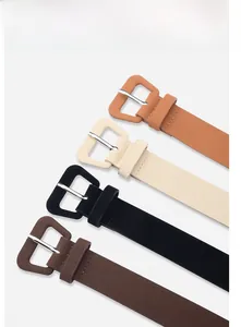 Detail showing set of four skinny leather belts in brown, black, beige, and camel colors