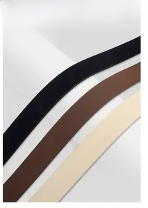 Close-up of faux leather belt straps in black, dark brown, and beige with grainy texture